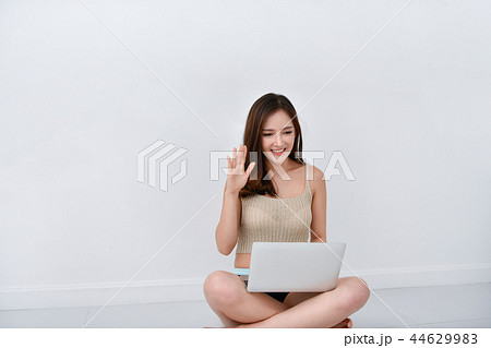 Beautiful girl in casual wear playing computer at home. Beautiful girl in casual wear playing computer at home. 44629983