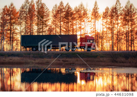 Red truck on a road at sunset 44631098