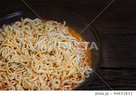 Instant noodles in bowl on wooden background. 44631631