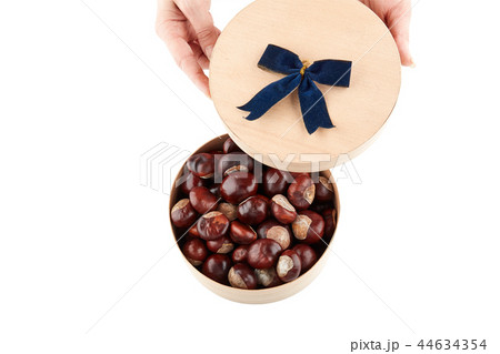 Chestnuts in round wooden box. Isolated Chestnuts in round wooden box. Isolated 44634354