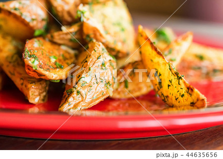 Baked potato wedges with dill and spices close 44635656
