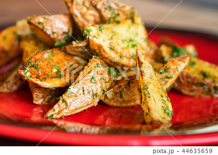 Baked potato wedges with dill and spices close 44635659
