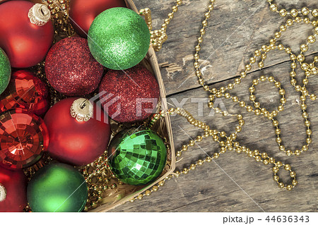 Christmas balls red, gold, green, beads lie in a  44636343