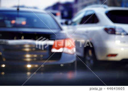 view of car in traffic jam / rear view of the landscape from window in car, road with cars, lights and the legs of the cars night view view of car in traffic jam / rear view of the landscape from window in car, road with cars, lights and the legs of the cars night view 44643605