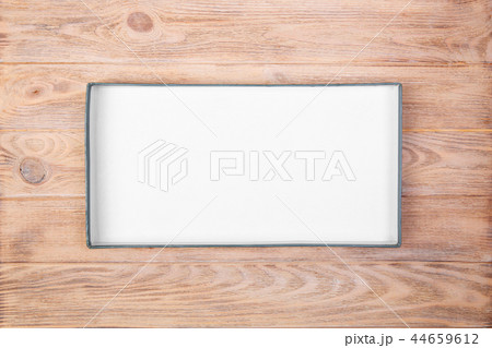 Opened cardboard box on wooden background Opened cardboard box on wooden background 44659612