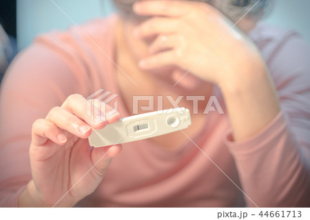 negative pregnancy test result held on cry woman 44661713