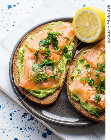 Rye bread avocado toasts with smoked salmon Rye bread avocado toasts with smoked salmon 44663396