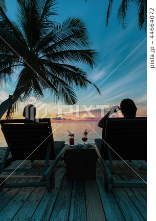 Woman sit on beach chair having cocktail drink  44664072