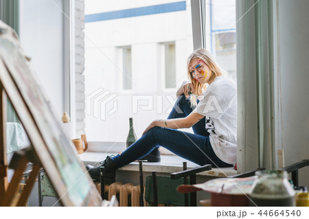 A young artist girl with a face and clothes in the paint 44664540