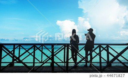 Silhouette of couples on wooden terrace At Seaside 44671827