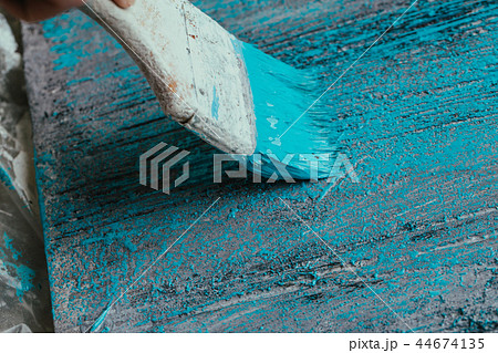 closeup hand use brush paint white blue on surface closeup hand use brush paint white blue on surface 44674135