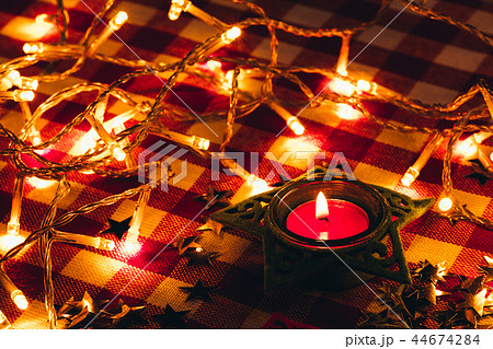 candle and garland lights in the background  44674284