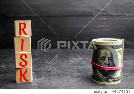 Dollars and the inscription "Risk" on wooden block 44674557