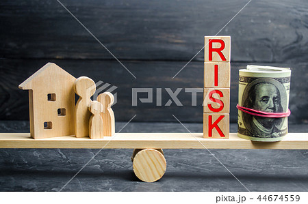 wooden house and cubes with the word risk. wooden house and cubes with the word risk. 44674559