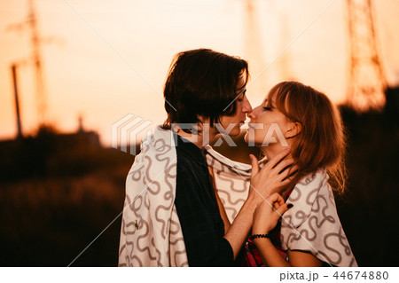 guy and the girl are standing against the sunset guy and the girl are standing against the sunset 44674880