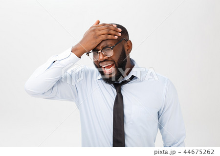 Portrait of desperate annoyed black male screaming in rage and anger tearing his hair out while Portrait of desperate annoyed black male screaming in rage and anger tearing his hair out while 44675262