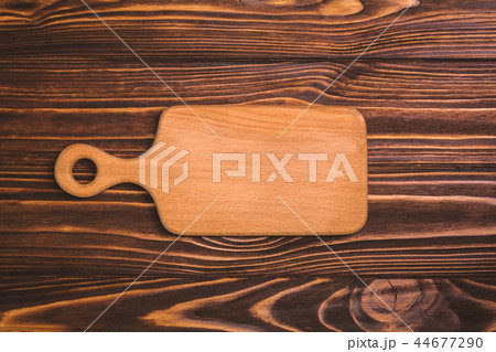 Kitchen cutting board on a wooden background, top view Kitchen cutting board on a wooden background, top view 44677290