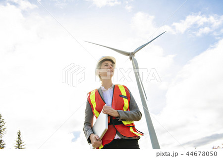 A Technician woman Engineer in Wind Turbine Power Generator Station 44678050