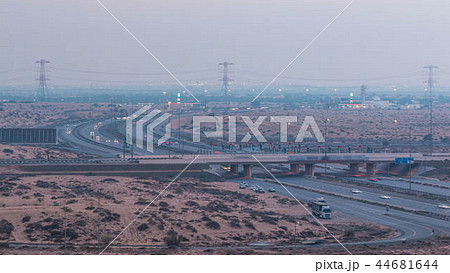 Highway roads with traffic day to night timelapse in a big city from Ajman to Dubai before sunset. Transportation concept. Highway roads with traffic day to night timelapse in a big city from Ajman to Dubai before sunset. Transportation concept. 44681644