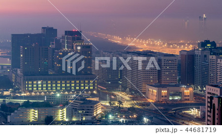 Abu Dhabi city skyline with skyscrapers before sunrise from above night to day timelapse Abu Dhabi city skyline with skyscrapers before sunrise from above night to day timelapse 44681719