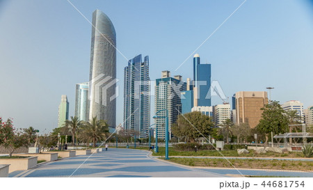 Corniche boulevard beach park along the coastline in Abu Dhabi timelapse with skyscrapers on background. Corniche boulevard beach park along the coastline in Abu Dhabi timelapse with skyscrapers on background. 44681754