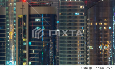 Window of the multi-storey skyscrapers of glass and steel office lighting and people within timelapse Window of the multi-storey skyscrapers of glass and steel office lighting and people within timelapse 44681757