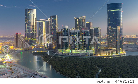 Buildings on Al Reem island in Abu Dhabi day to night timelapse from above. 44681811