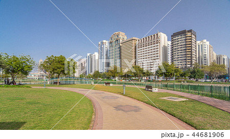 Corniche boulevard beach park along the coastline in Abu Dhabi timelapse hyperlapse with skyscrapers on background. Corniche boulevard beach park along the coastline in Abu Dhabi timelapse hyperlapse with skyscrapers on background. 44681906