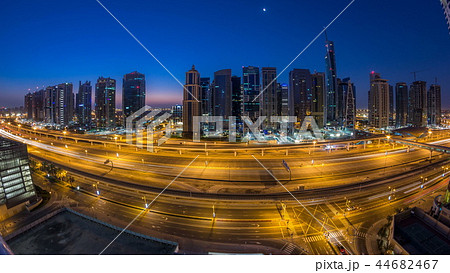 Aerial view of Jumeirah lakes towers skyscrapers night to day timelapse with traffic on sheikh zayed road. 44682467