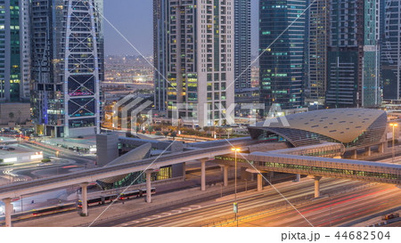 Aerial view of Jumeirah lakes towers skyscrapers day to night timelapse with traffic on sheikh zayed road. Aerial view of Jumeirah lakes towers skyscrapers day to night timelapse with traffic on sheikh zayed road. 44682504