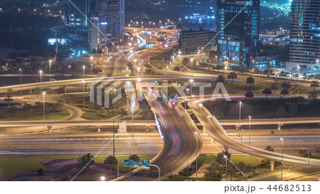 Aerial view of a road intersection in a big city night timelapse. Aerial view of a road intersection in a big city night timelapse. 44682513