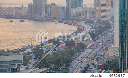 Dubai creek landscape day to night timelapse with boats and ship near waterfront 44682937