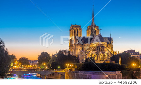Rear view of Notre Dame De Paris cathedral day to night timelapse after sunset. 44683206