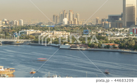 Dubai creek landscape timelapse with boats and ship in port and modern buildings in the background during sunset 44683209