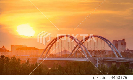 Sunset timelapse above the Bridge with the transport and clouds on the background. Central Asia, Kazakhstan, Astana Sunset timelapse above the Bridge with the transport and clouds on the background. Central Asia, Kazakhstan, Astana 44683763