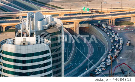 Aerial view of a highway intersection in Dubai, UAE, at sunset with traffic timelapse. 44684312