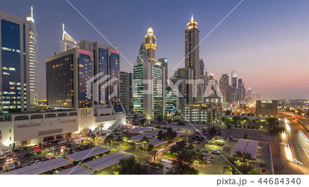 Downtown Dubai towers day to night timelapse. Aerial view of Sheikh Zayed road with skyscrapers after sunset. Downtown Dubai towers day to night timelapse. Aerial view of Sheikh Zayed road with skyscrapers after sunset. 44684340