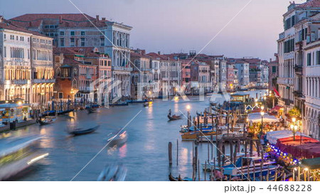 Grand Canal in Venice, Italy day to night timelapse. View on gondolas and city lights from Rialto Bridge. 44688228