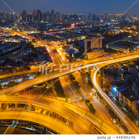 Cars driving on bridge roads shaped curve highways with skyscrap 44690246