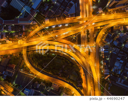 Cars driving on bridge roads shaped curve highways with skyscrap 44690247