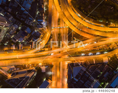 Cars driving on bridge roads shaped curve highways with skyscrap 44690248