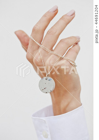 Hand holding stylish necklace. Hand holding stylish necklace. 44691204