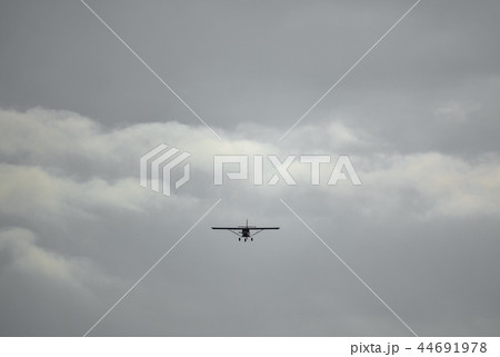 Light aircraft flying over cloudy sky background Light aircraft flying over cloudy sky background 44691978