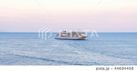 Passenger ship cruising on water at sunset 44694408