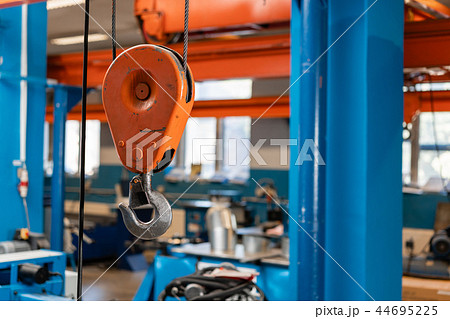 Crane hook. The system of pulleys and ropes, a hanging mechanism in the production area. Movement Crane hook. The system of pulleys and ropes, a hanging mechanism in the production area. Movement 44695225