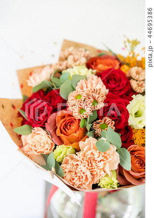 beautiful spring bouquet. flowers arrangement with various of colors in glass vase on old table 44695386