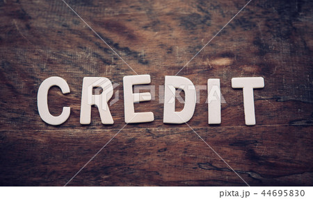 The word "CREDIT" is arranged from a wooden 44695830