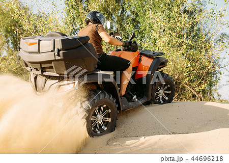 Atv riding in action, sand quarry on background 44696218