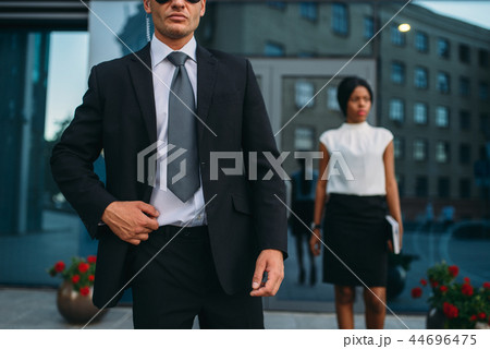Bodyguard in suit and sunglasses, female VIP 44696475