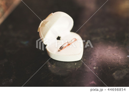 Two golden wedding rings isolated background concept 44698854